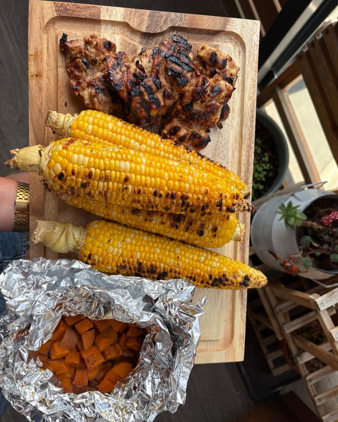 A hearty grilled plate with vegetables and protein, plated at home
